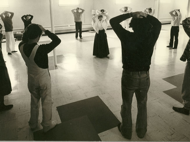 Ruth Denison (center of circle) studied in Burma in the early 1960s and is shown here leading a mindful movement session.
