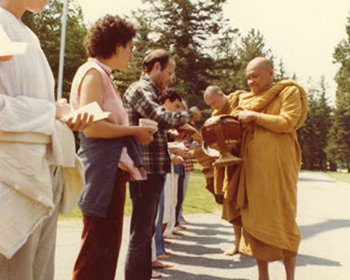 Thai meditation master Ven. Ajahn Chah on alms round at IMS during his 1979 visit.