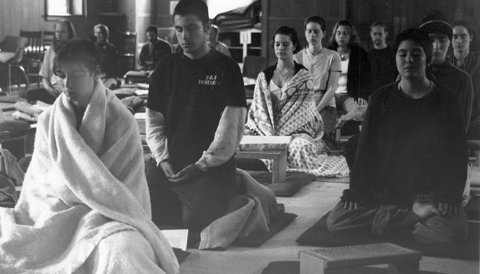 Young adults practicing in the meditation hall.